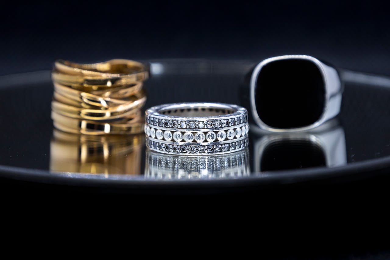 Close-up of luxurious gold and silver rings displaying elegance and opulence.