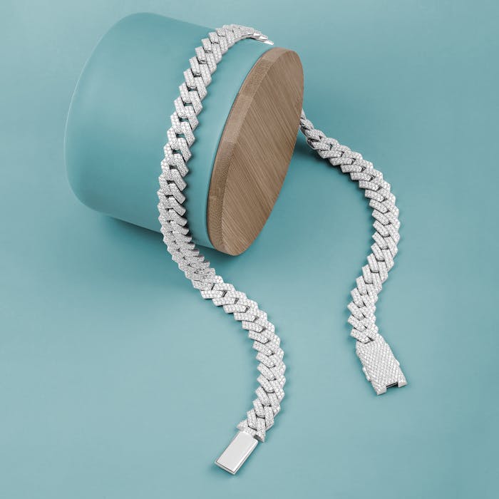 Close-up of a stylish silver bracelet displayed on a turquoise background for a modern look.