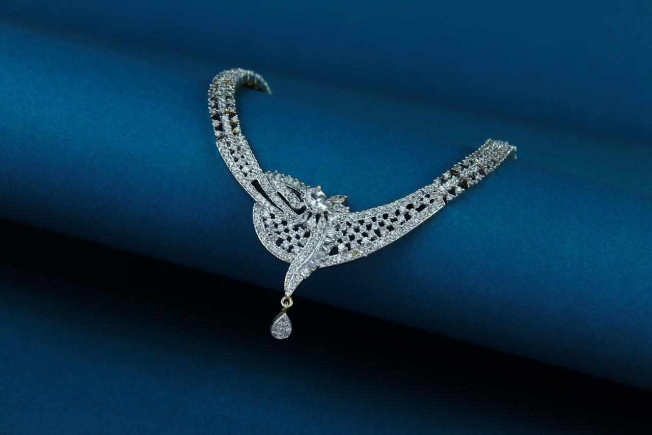 Close-up of a luxury diamond necklace on a deep blue background.