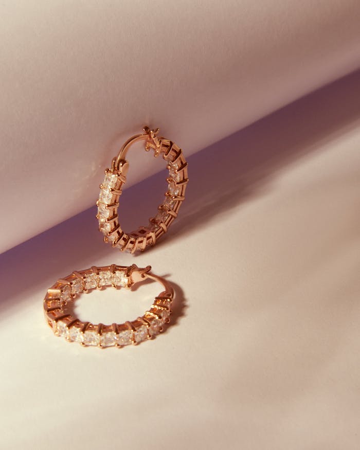 Close-up of exquisite diamond hoop earrings with rose gold setting, perfect for fashion and elegance.